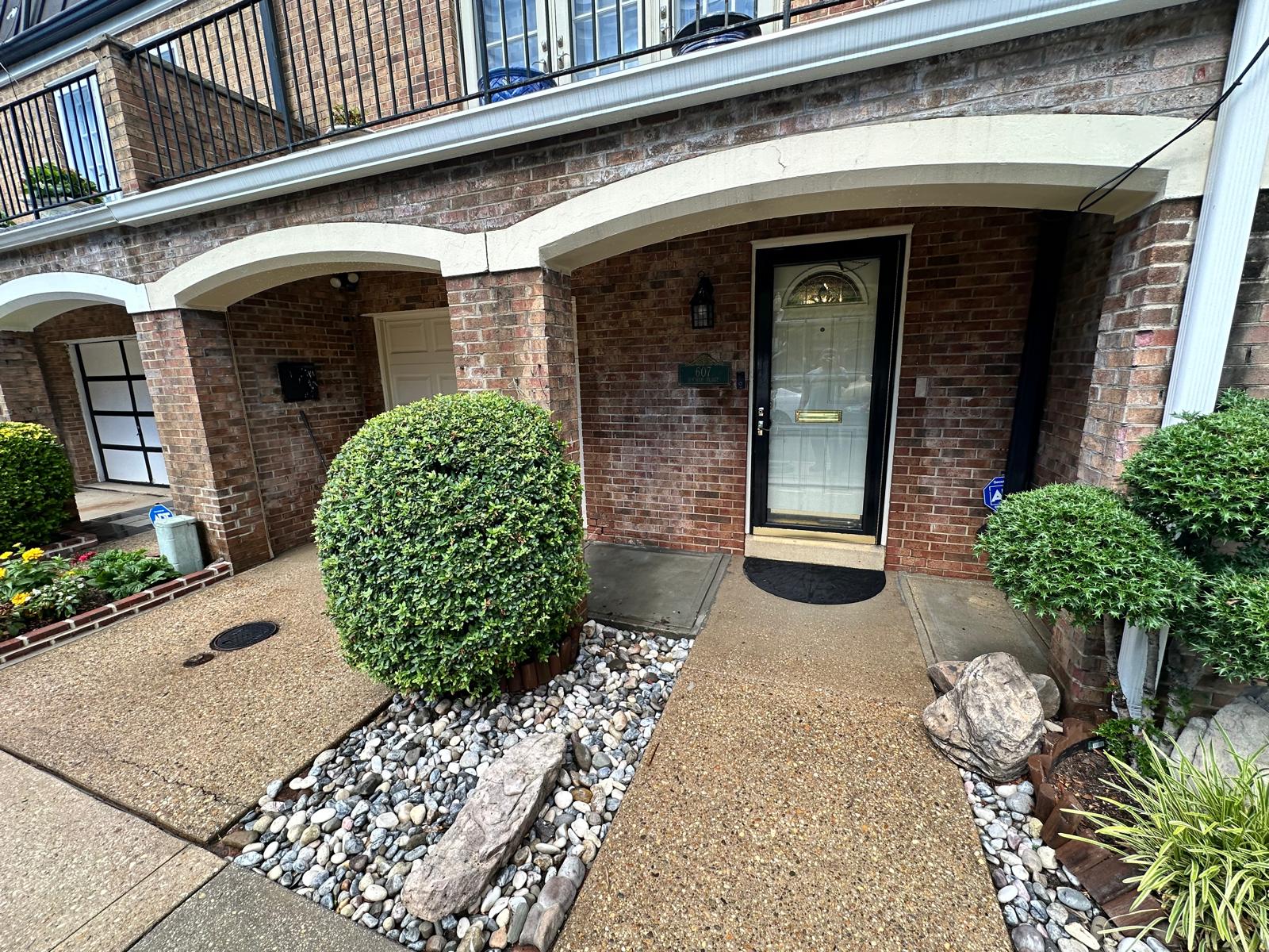 Front entry landscaped with river rock and trimmed shrubs